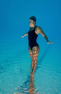 Female model swimming in pool