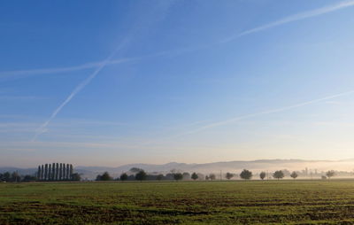 Scenic view of field against clear blue sky