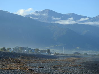 Scenic view of field and mountains against sky