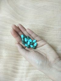 Close-up of human hand holding shoe