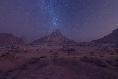 Scenic view of mountains against sky at night