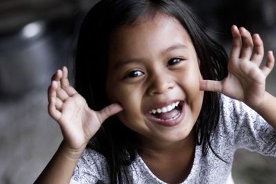 Portrait of cute smiling girl gesturing 