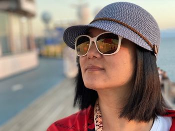 Close-up of woman wearing sunglasses and cap