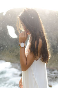 Side view of woman standing in water