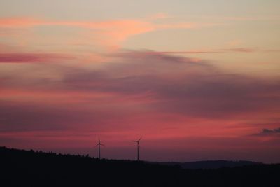 Low angle view of silhouette windmill against sky during sunset