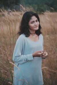 Portrait of smiling young woman standing outdoors