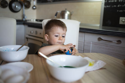 High angle view of cute baby girl eating food on table