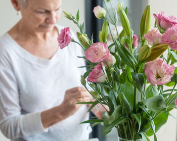 Close-up of man holding bouquet in vase