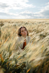 Portrait of young woman in field