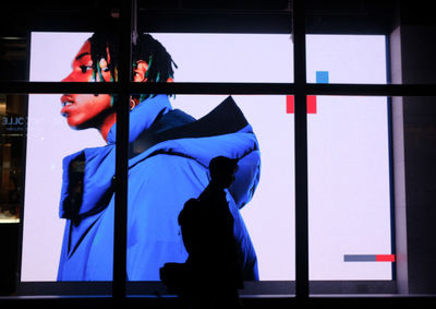 Reflection of woman on glass window