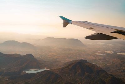 Aerial view of mountains against sky during sunset