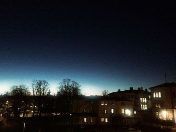 Buildings against sky at night