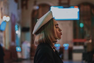 Portrait of young woman wearing hat