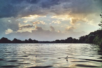 Scenic view of lake against cloudy sky