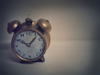 Close-up of clock on table