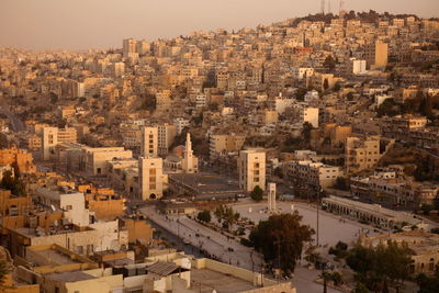 Aerial view of buildings in town during sunset