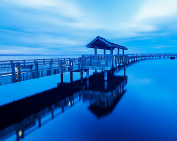 View of swimming pool by sea against sky