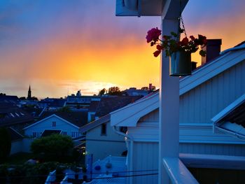 Houses against sky during sunset