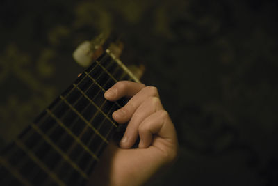 Close-up of hand playing guitar