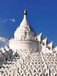 Low angle view of traditional building white pagoda against sky