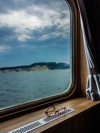 Low section of boat in sea against sky