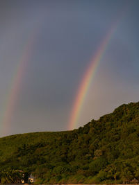 Scenic view of rainbow over mountains