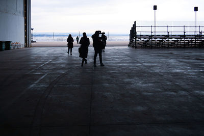 Rear view of people walking on street