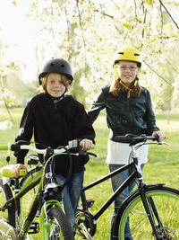 Boy and girl cycling in park