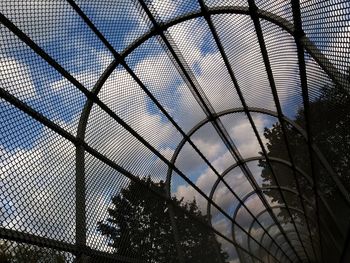 Low angle view of chainlink fence against sky