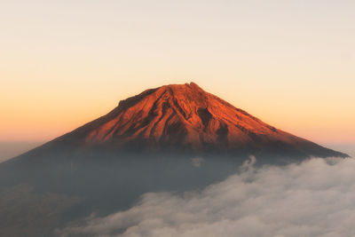 View of volcanic mountain against sky during sunset