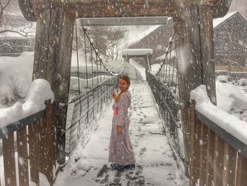 Woman standing in snow