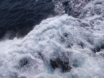 High angle view of waves splashing in sea