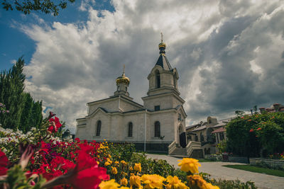 Low angle view of church against cloudy sky