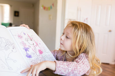 Young woman reading book at home