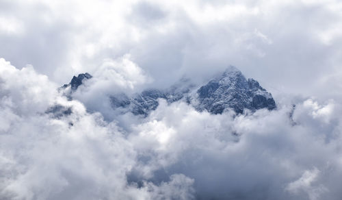 Low angle view of snowcapped mountain against sky