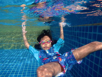 Portrait of boy swimming in pool