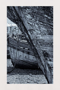 Abandoned boat on beach against sky