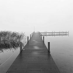 Pier over sea against clear sky