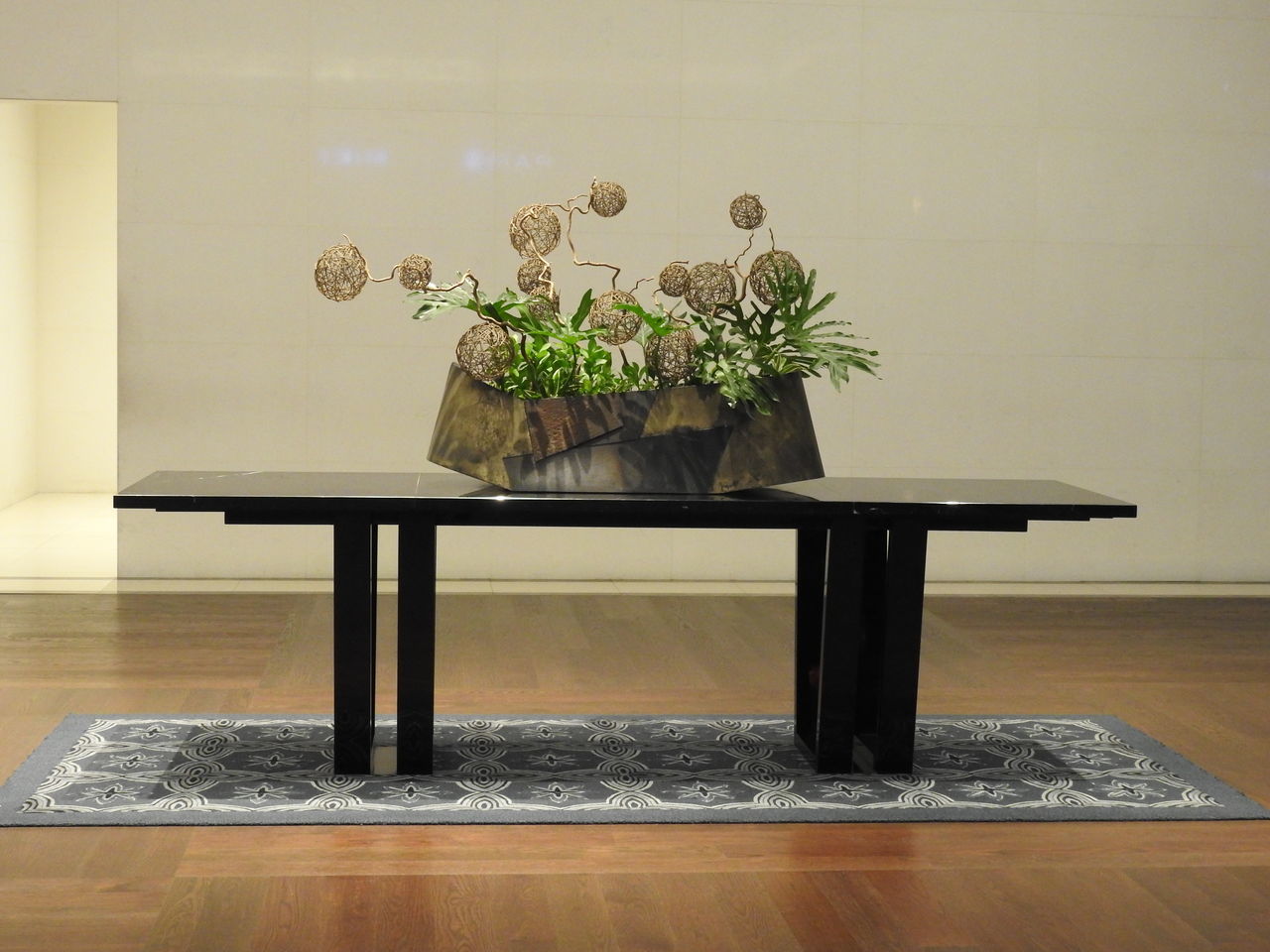 POTTED PLANT ON TABLE BY WALL AT HOME