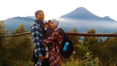 Rear view of man and woman against sky