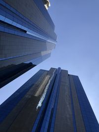 Low angle view of modern buildings against clear blue sky