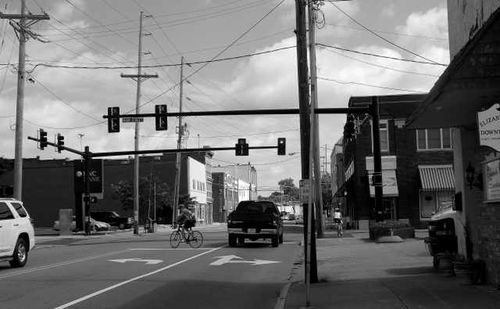 View of city street against cloudy sky