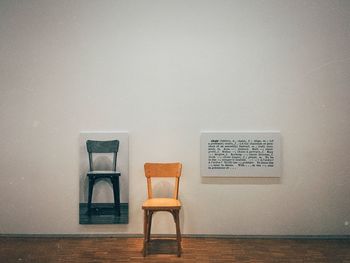 Close-up of chairs on table at home