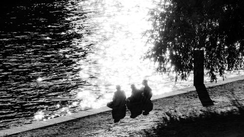 Rear view of people walking on water