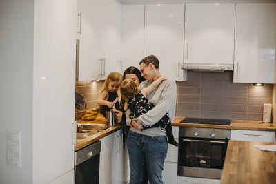 Women with two daughters in kitchen