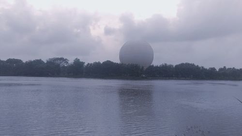 View of hot air balloon in lake against sky