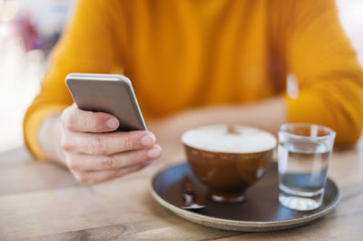 Hand of man holding smartphone, close-up