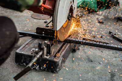 Close-up of grinder cutting metal in factory