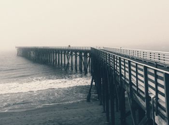 Pier over sea against clear sky