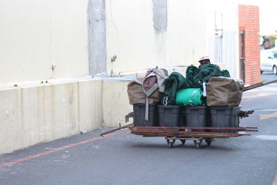 Garbage bin on street against buildings